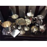 A collection of nickel and brass ware.