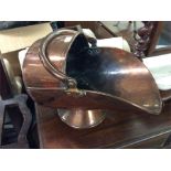 A copper coal scuttle.