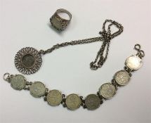 A silver coin necklace together with matching ring