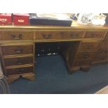 A yew wood twin pedestal desk.