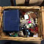 A large wicker box of costume jewellery.