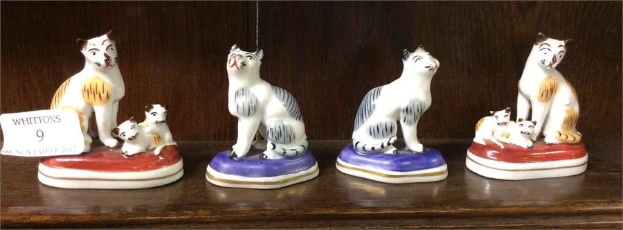 Two pairs of Staffordshire type cats.