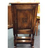 An oak panelled Jacobean style bedside cabinet.