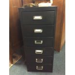 A six drawer metal filing unit.