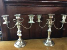 A pair of plated candelabra.