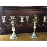 A pair of plated candelabra.