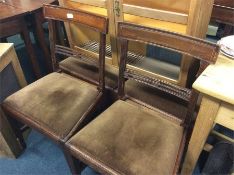 A set of four Georgian mahogany dining chairs with