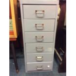 A six drawer metal filing unit.