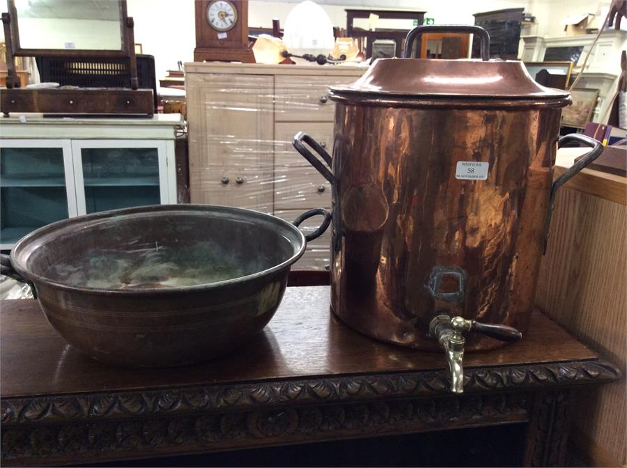 A large copper samovar together with a bowl.