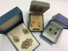 Two pairs of gold earrings in boxes together with