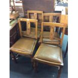 A set of four oak dining chairs.