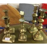 Three pairs of brass candlesticks.