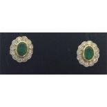 A pair of oval emerald and diamond cluster earring