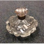 A small silver rimmed scent bottle with cut glass