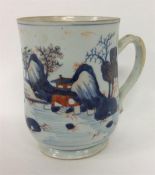 A large Oriental mug decorated with houses and tre