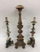 A group of three Continental wooden candlesticks.