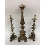 A group of three Continental wooden candlesticks.