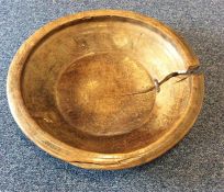 A large wooden rustic bowl. Est. £50 - £80.