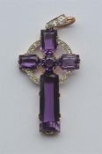 An Antique amethyst and diamond cross in gold claw