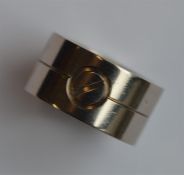 CARTIER: A large wide 18 carat band. Numbered CJ97