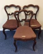 A set of three mahogany hoop back dining chairs wi