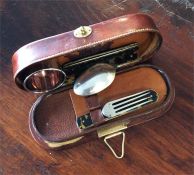 A leather mounted travelling set. Est. £50 - £80.