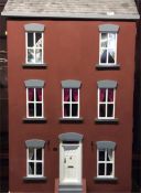 A large three storey doll's house completely furni