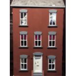 A large three storey doll's house completely furni