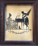A framed and glazed silhouette of a couple playing