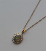 A good quality opal and diamond pendant in the for