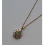 A good quality opal and diamond pendant in the for