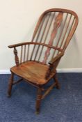 An elm stick back carver chair on turned supports.