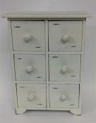 A small painted six drawer chest. Approx. 36 cms h