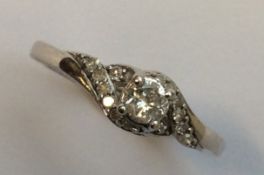 An 18 carat white gold single stone ring in claw m