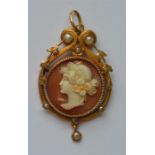 An Antique circular cameo pendant with loop top an