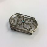 A silver and glass clip with ribbon decoration and