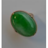 A good jade oval signet ring, the mount engraved w