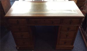 A small oak twin pedestal desk. Est. £60 - £80.
