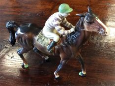 A Beswick horse and rider. Est. £30 - £40