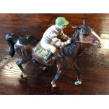 A Beswick horse and rider. Est. £30 - £40