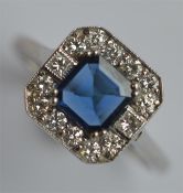 A stylish sapphire and diamond cluster ring in cla