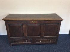An Antique oak hinged top mule chest with drawers