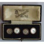 A pair of 9 carat and MOP cufflinks with pearl ins