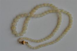 A good graduated string of circular opal beads wit