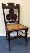 A carved hall chair with cane seat. Est. £30 - £50