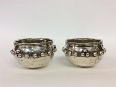 A pair of unusual Glastonbury bowls with ball deco