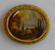 An oval miniature of a mountain scene in pierced f