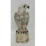 A large alabaster figure of a peregrine falcon on