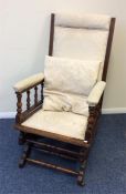 An Edwardian American rocking chair with carved de