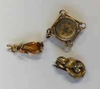 A small gold compass together with a charm etc. Ap